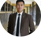 Clausewitz M., in a suit and tie in a university corridor.